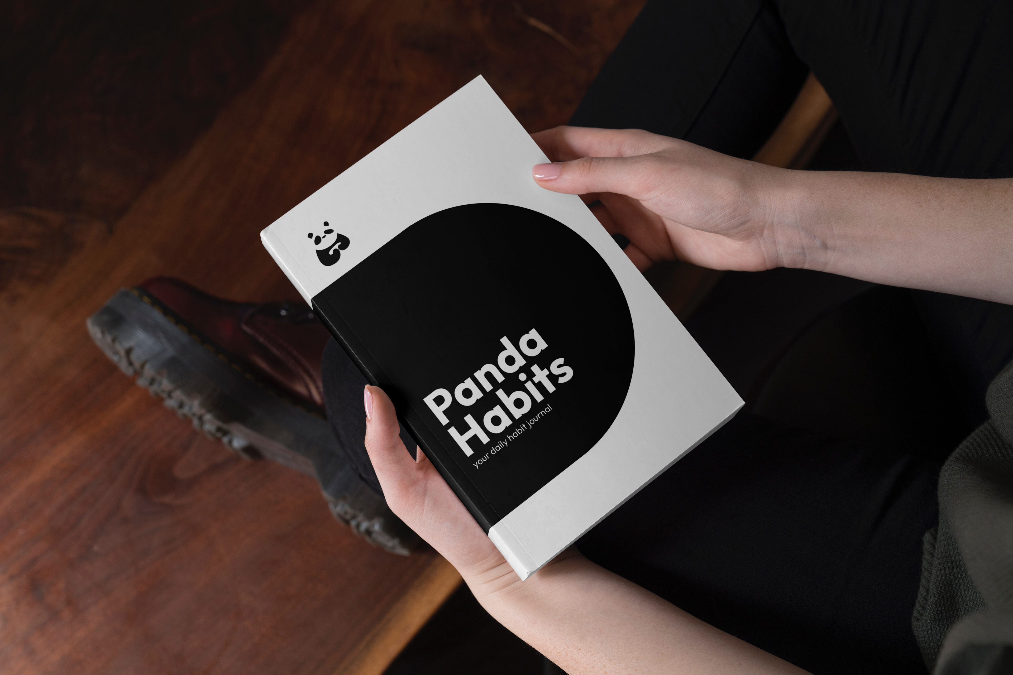 The Panda Habits journal held in hand