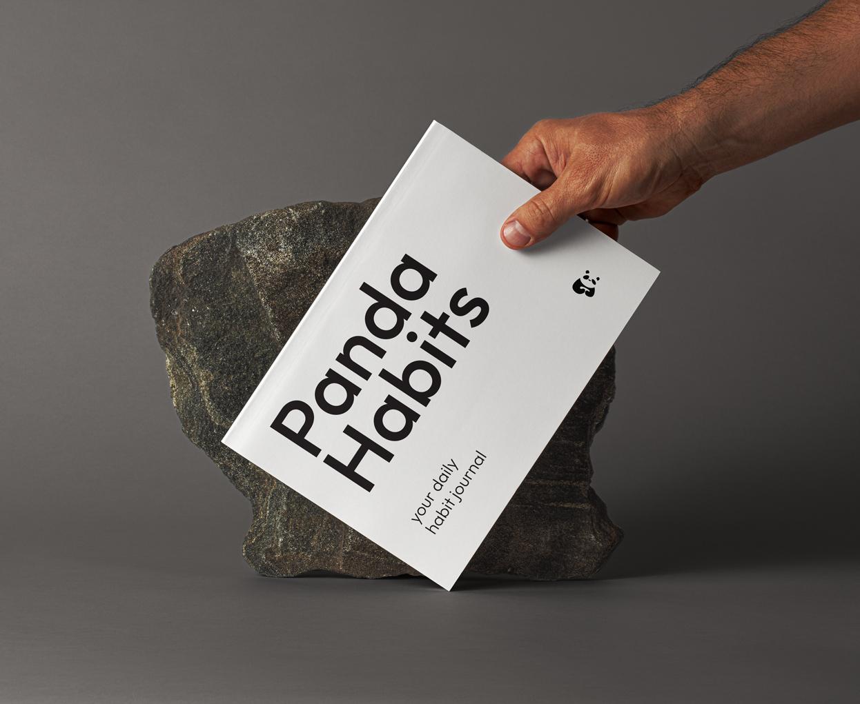 The Panda Habits journal held in hand
